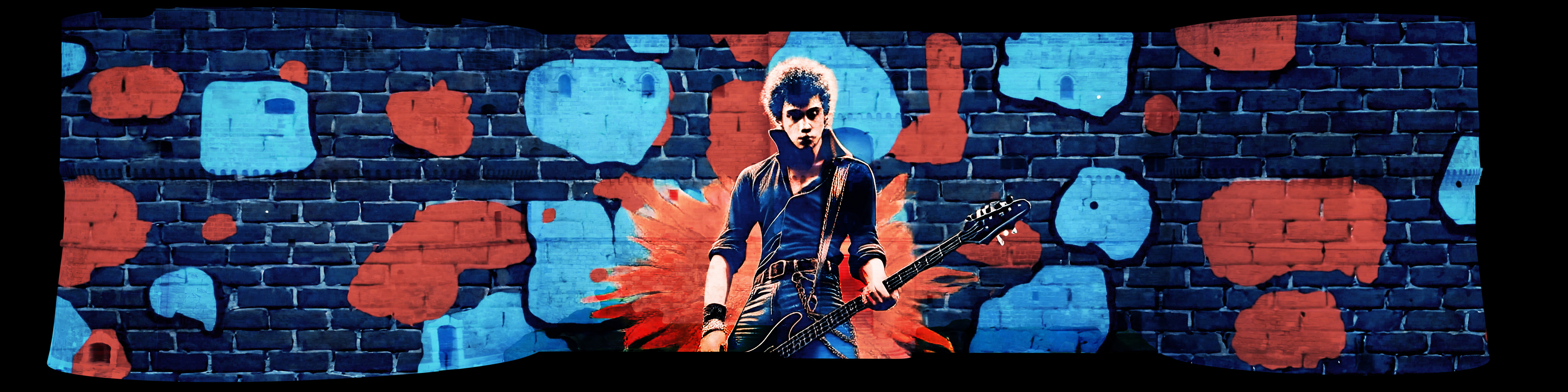 Paul Simonon suona davanti a un muro di mattoni blu e rosso
